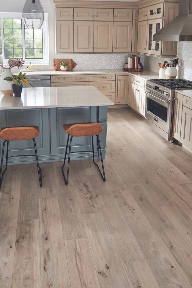 light white oak look laminate in modern kitchen with blue island and leather barstools